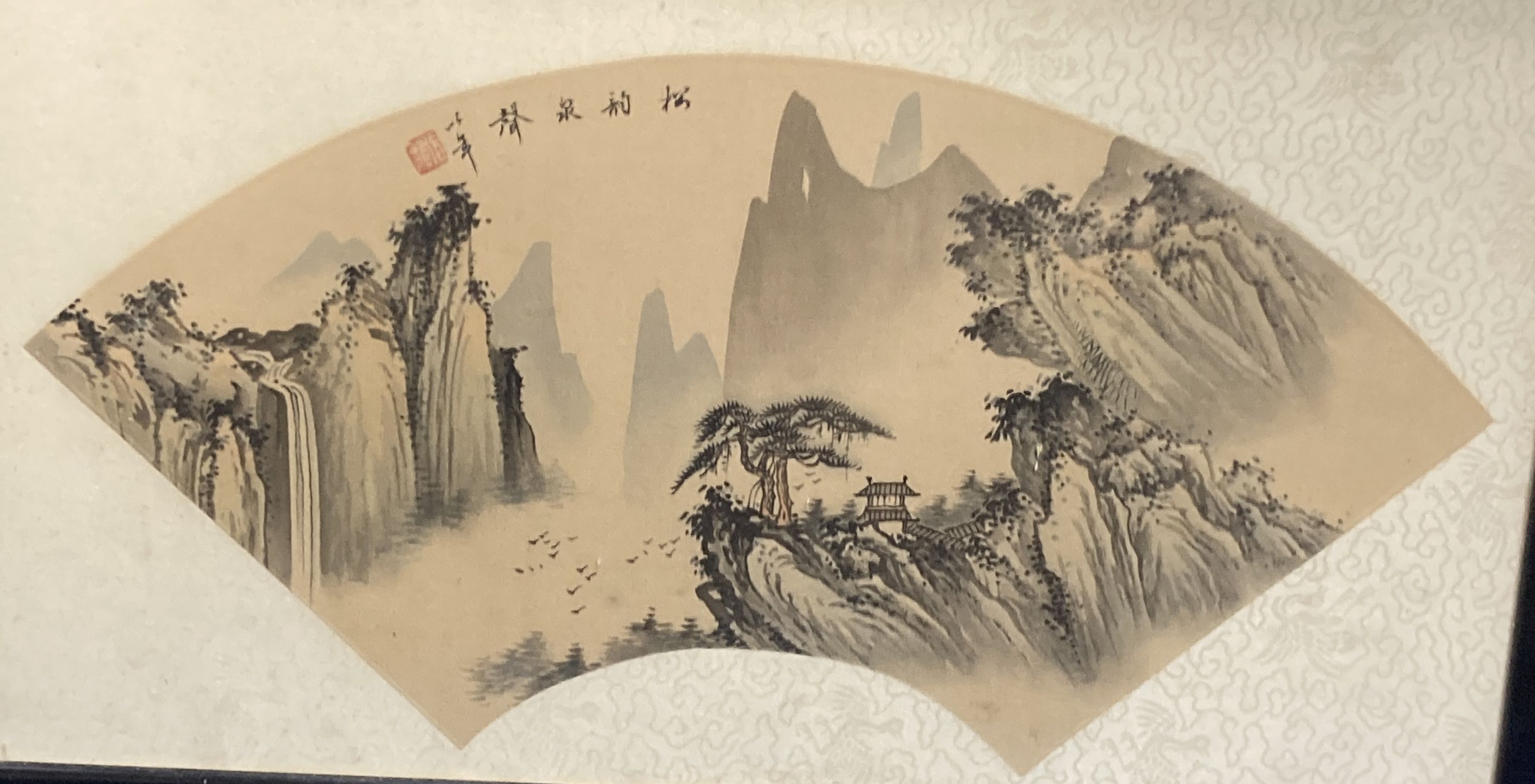 A Chinese painted fan leaf depicting a mountain scene, 43 x 21cm and a Chinese picture of peonies